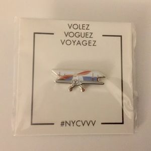 Volez, Voguez, Voyagez Louis Vuitton Exhibit Pin